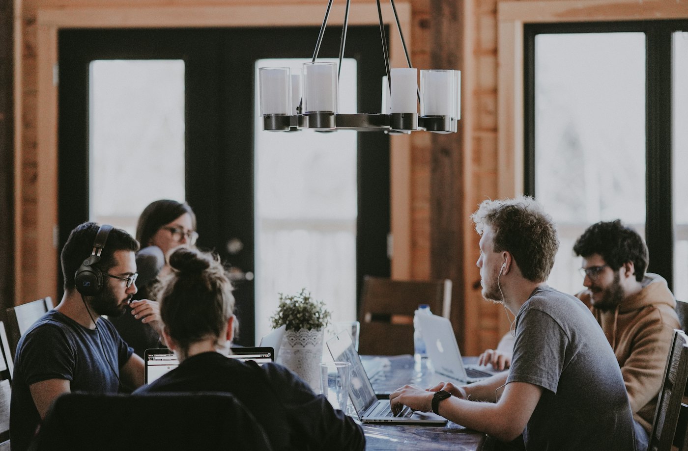 Hiring managers in a working session around a laptop.